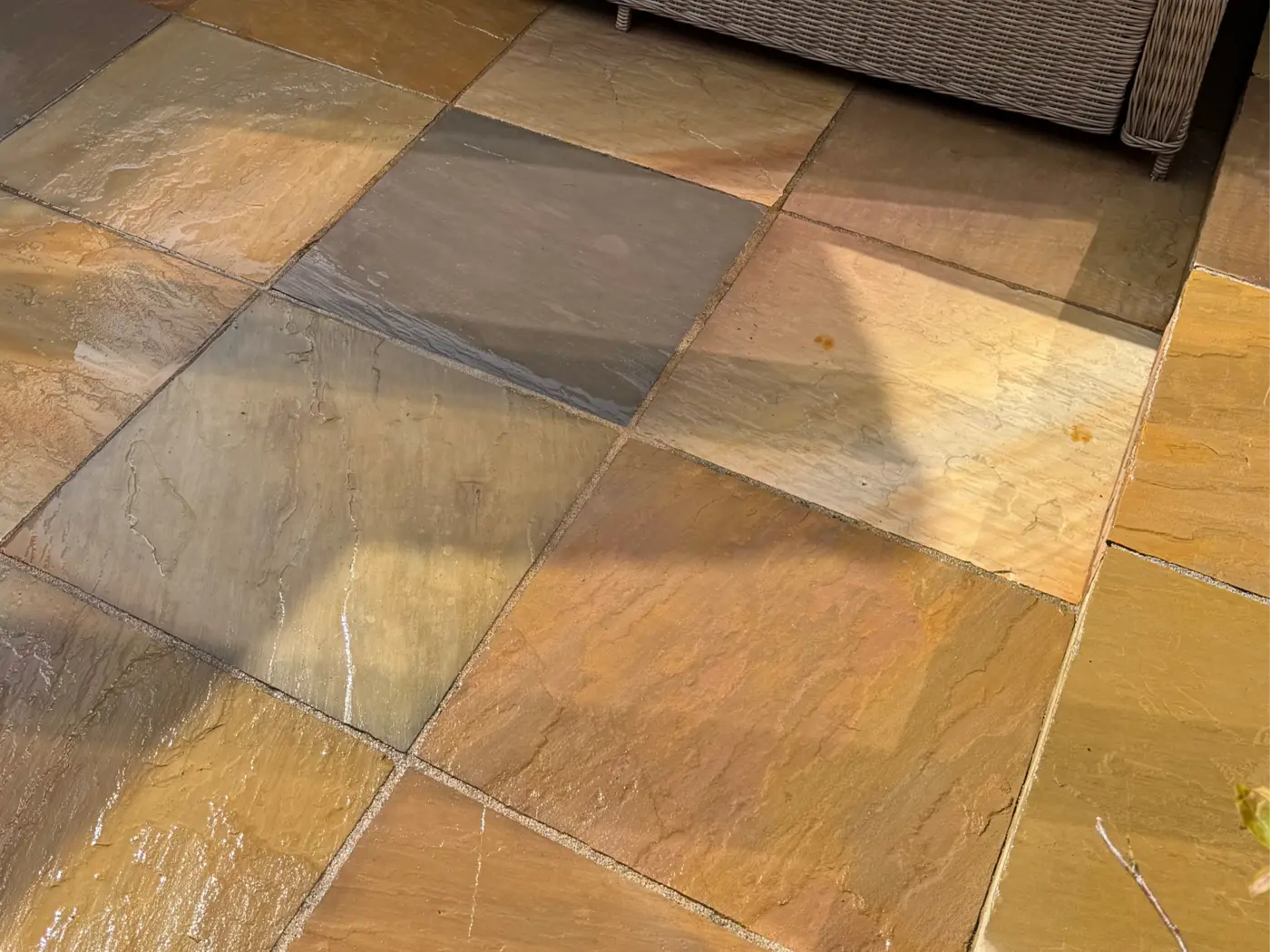 Freshly cleaned Indian sandstone patio slabs, still wet after washing