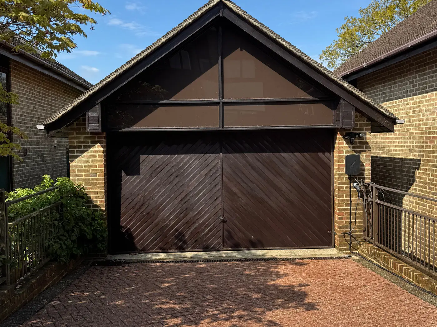Block paving driveway cleaned back to its original colour in front of a Kent garage