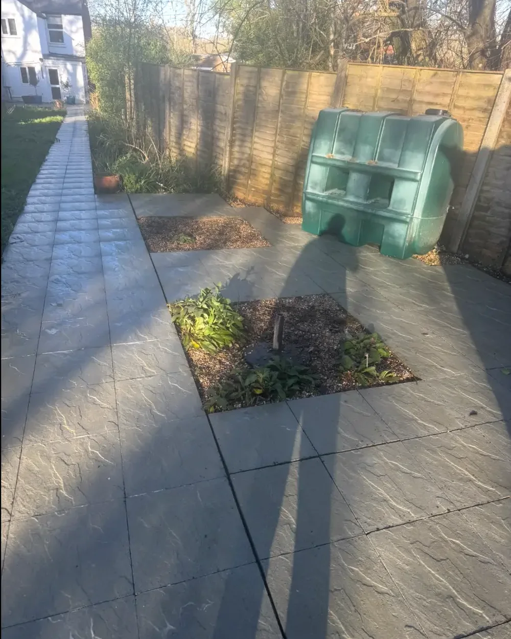The same paving slab patio cleaned back to a crisp grey finish