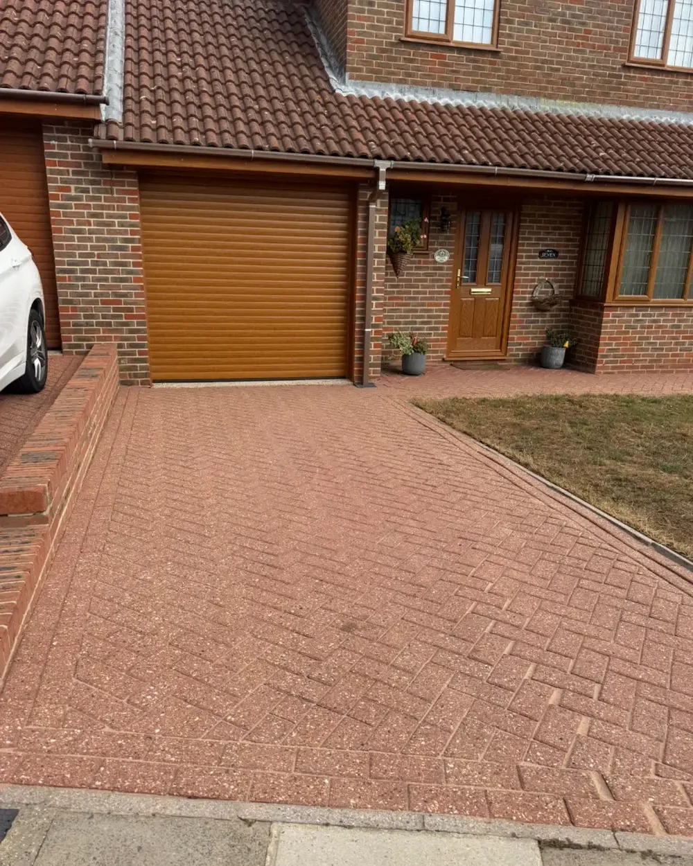 The same driveway freshly washed, with the original red blocks visible again